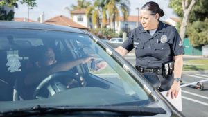 Poliziotta che chiede documenti automobilista